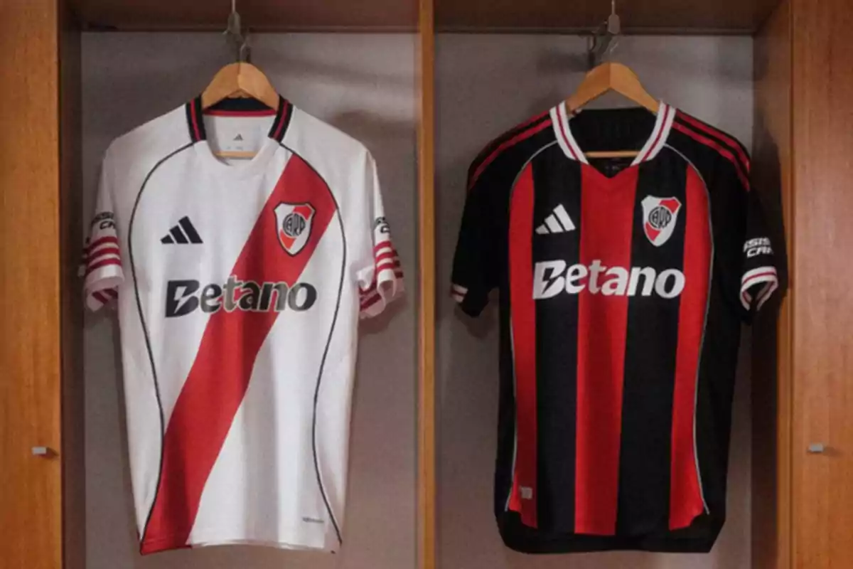 Two River Plate soccer jerseys hanging in a locker room, one white with a red sash and the other black with red stripes Two River Plate soccer jerseys hanging in a locker room, one white with a red sash and the other black with red stripes