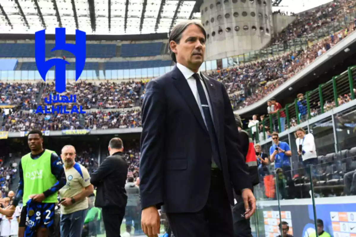 Soccer coach in a suit walking in a stadium full of fans with the Al Hilal crest superimposed on the image Soccer coach in a suit walking in a stadium full of fans with the Al Hilal crest superimposed on the image