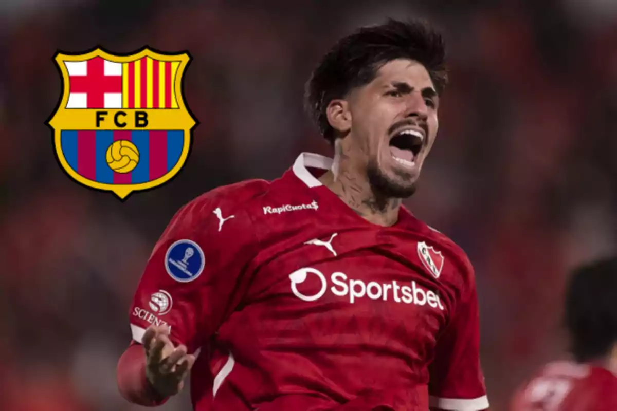 Soccer player in a red uniform celebrating with the FC Barcelona crest in the background