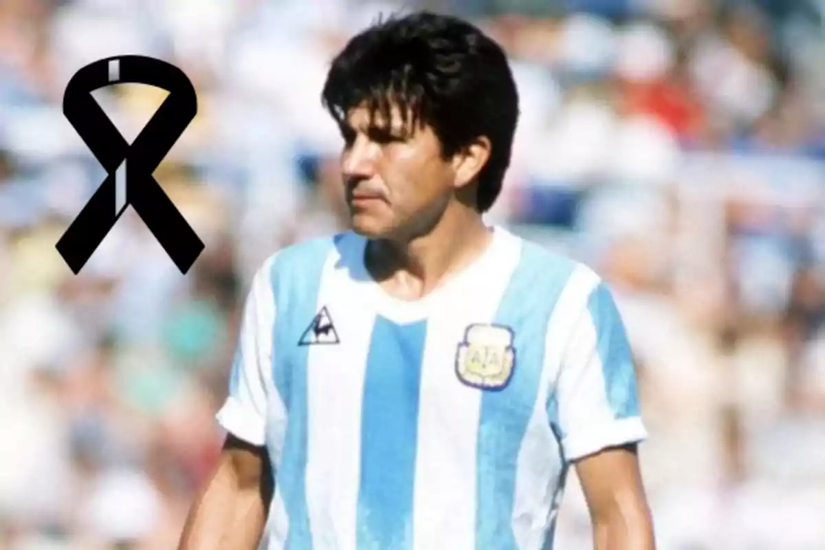 A player wearing the Argentina jersey and a black mourning ribbon in the corner of the image.