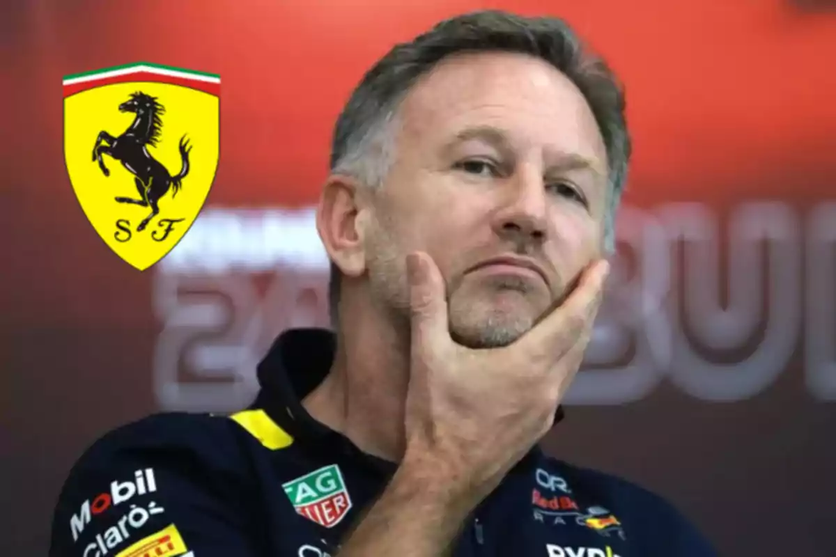 Pensive man with a short beard and Red Bull uniform, in the background a Ferrari logo on a red backdrop.