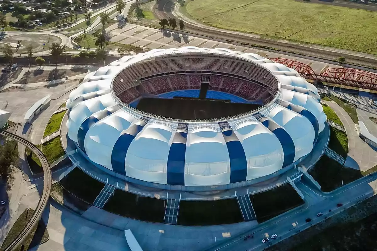 Aerial view of a modern stadium with a distinctive architectural design and a green environment. Aerial view of a modern stadium with a distinctive architectural design and a green environment.