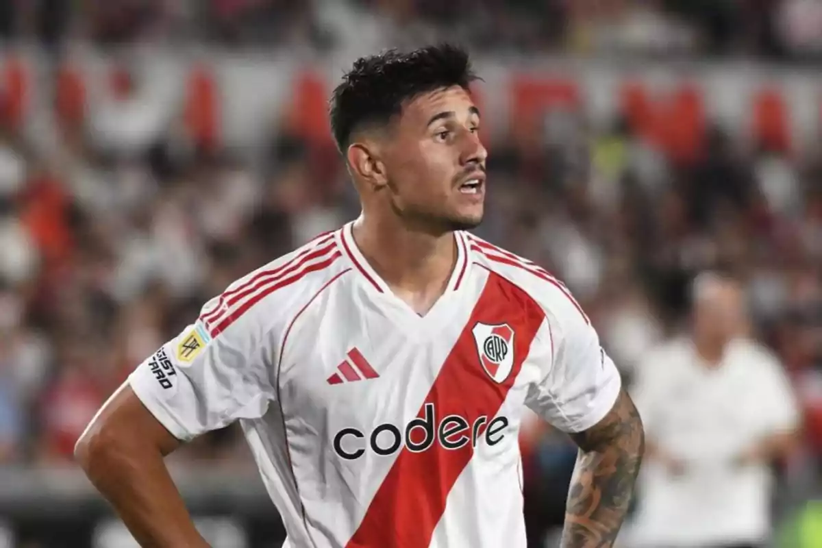 Soccer player wearing a River Plate jersey during a match Soccer player wearing a River Plate jersey during a match