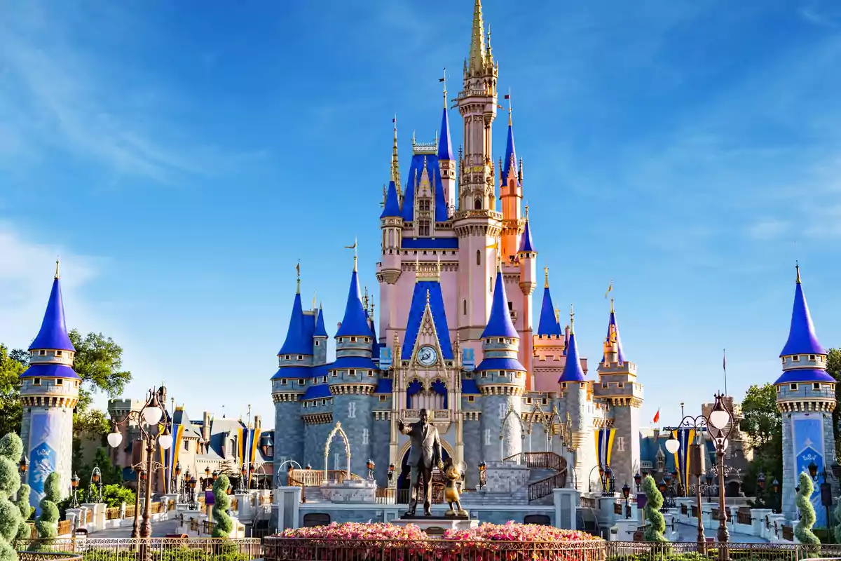 A fairy tale castle with blue and gold towers under a clear sky. A fairy tale castle with blue and gold towers under a clear sky.