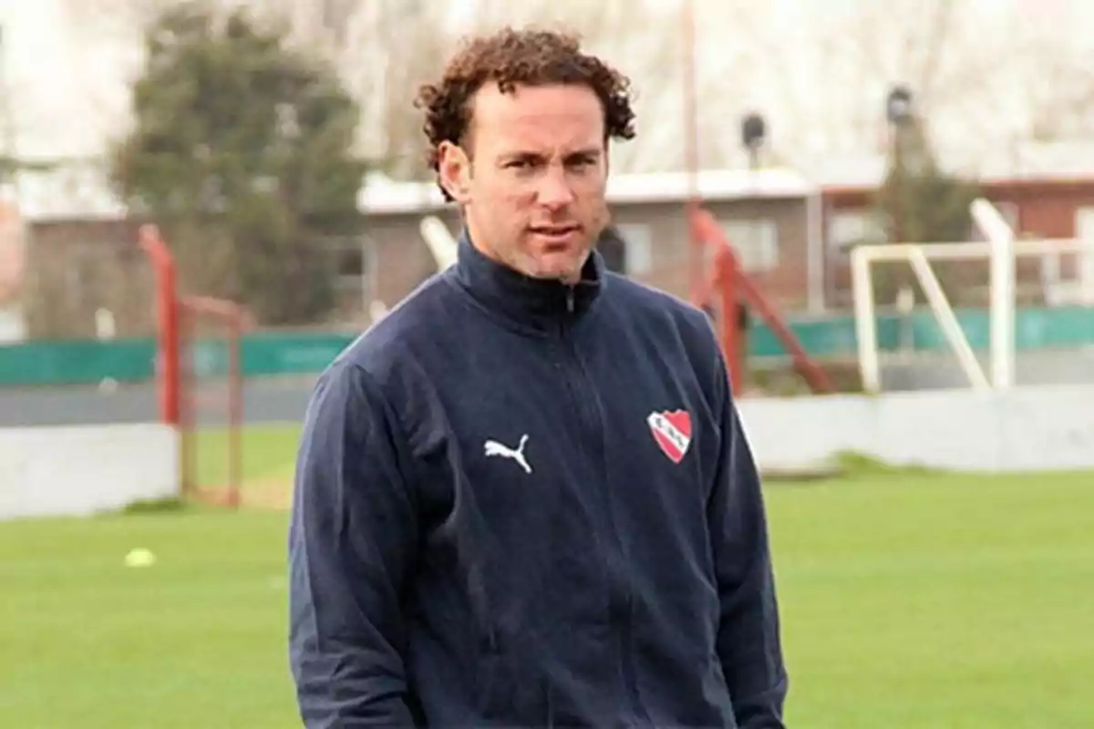 Man with a sports jacket from a soccer team on a training field. Man with a sports jacket from a soccer team on a training field.