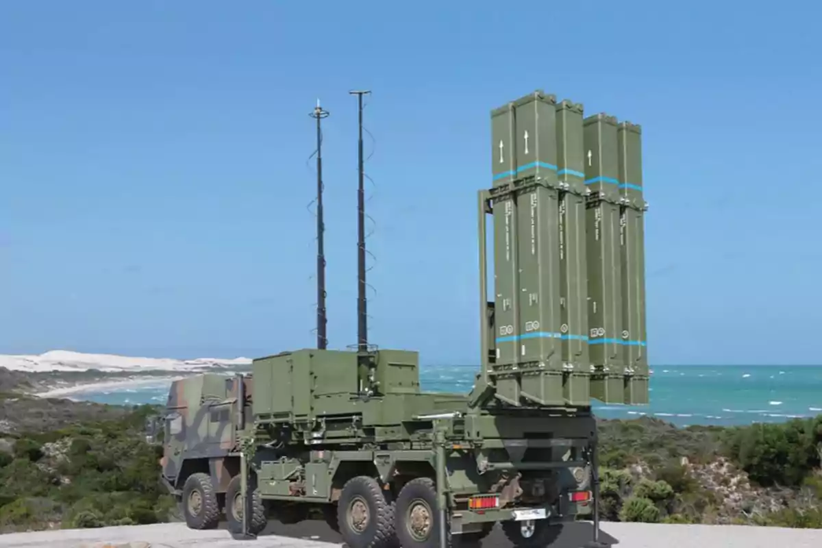 Military truck equipped with a missile launch system by the sea in a natural environment Military truck equipped with a missile launch system by the sea in a natural environment