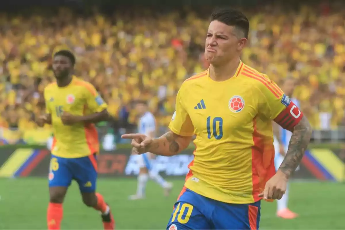 Colombian player celebrating a goal in a stadium full of fans wearing yellow uniforms and a captain's armband Colombian player celebrating a goal in a stadium full of fans wearing yellow uniforms and a captain's armband