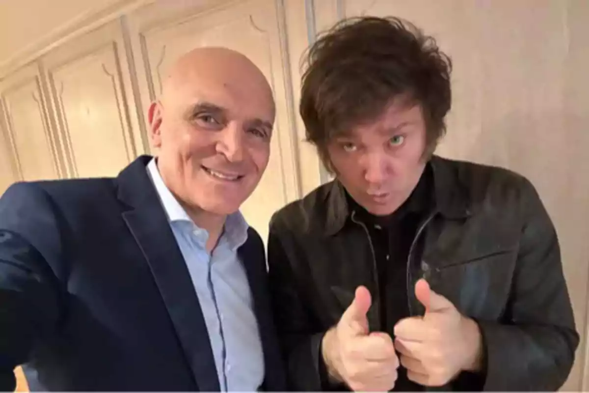 Two people posing for a photo, one of them with a thumbs up. Two people posing for a photo, one of them with a thumbs up.