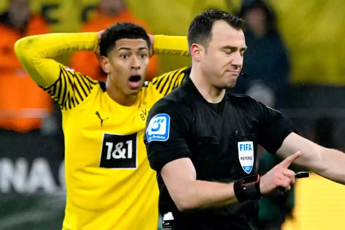 Soccer player with a surprised expression behind a referee who appears to be making a decision during a match Soccer player with a surprised expression behind a referee who appears to be making a decision during a match