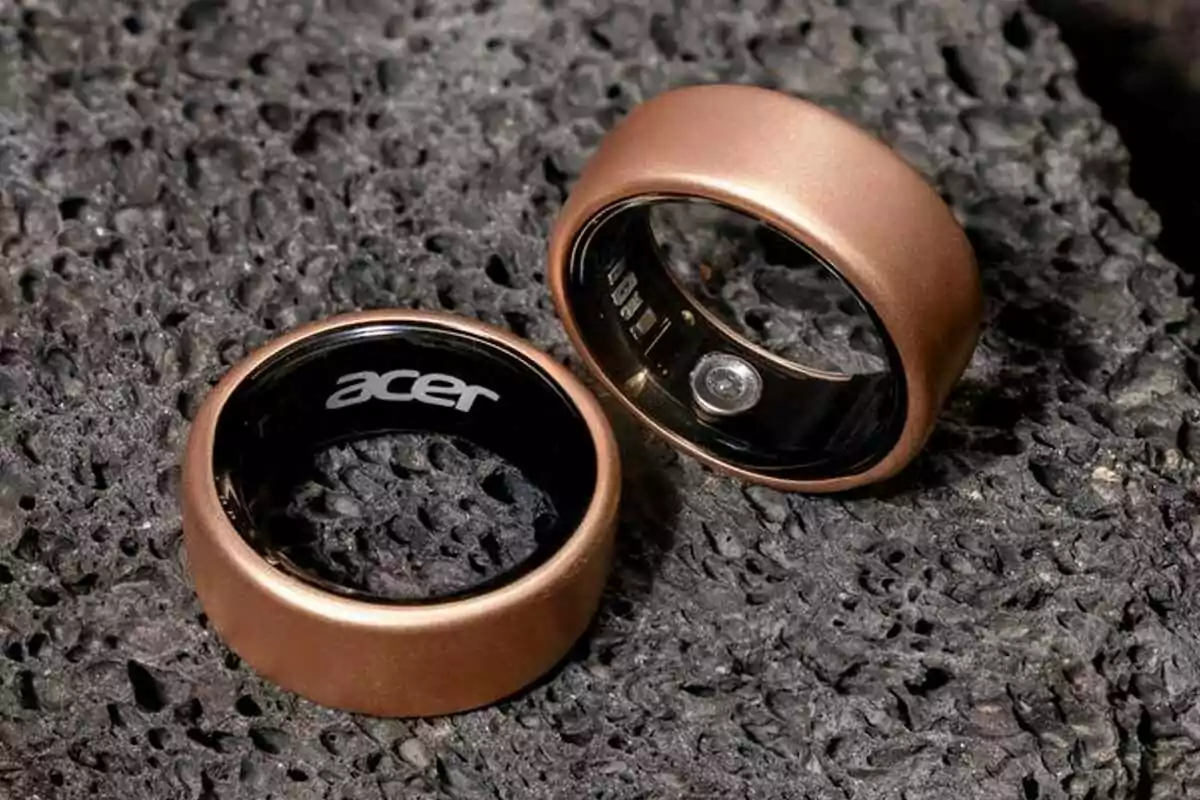 Two copper-colored rings on a dark stone surface. Two copper-colored rings on a dark stone surface.