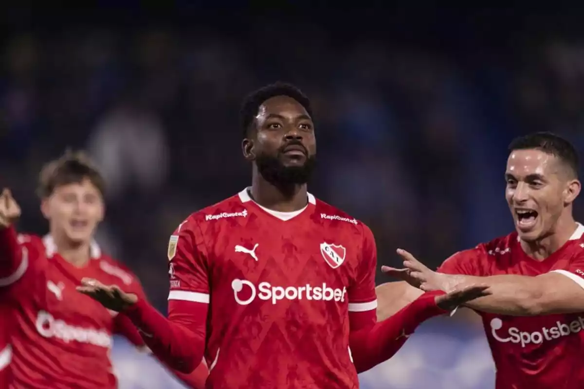 Soccer players in red uniforms celebrating on the field. Soccer players in red uniforms celebrating on the field.