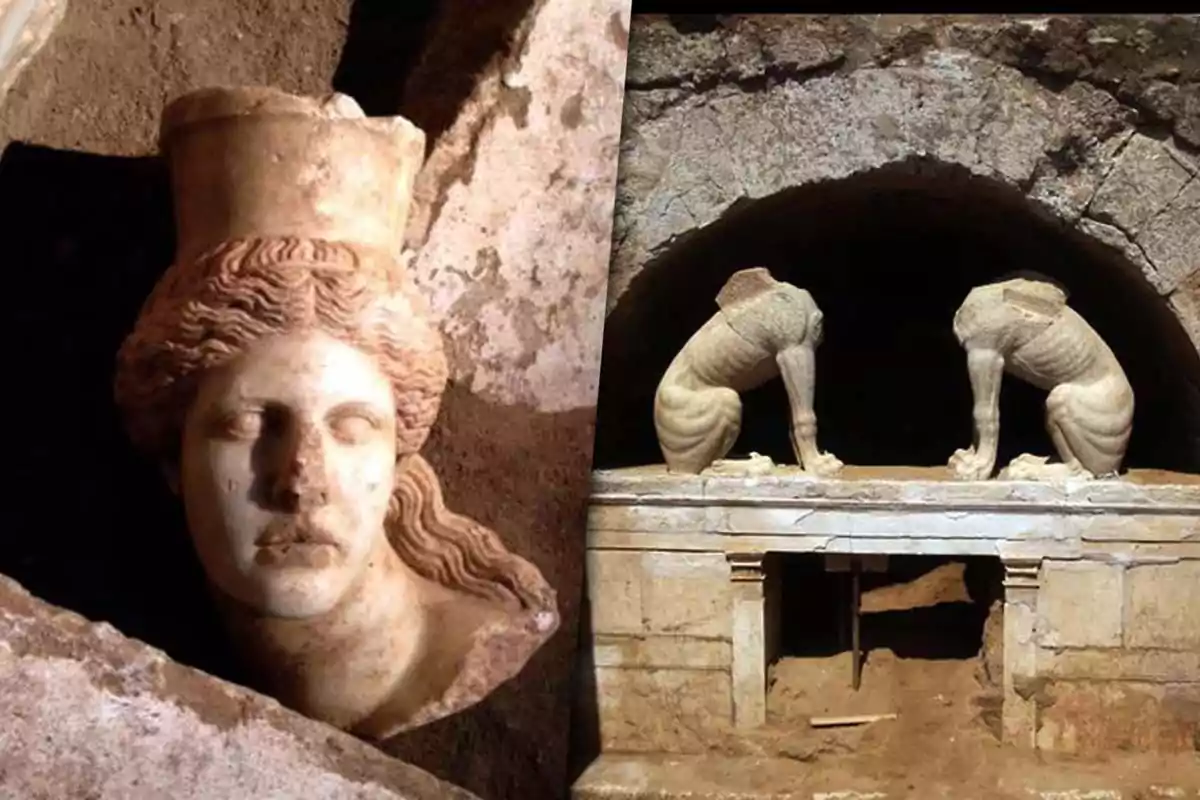 A sculpture of a marble head with a headdress next to an archaeological entrance flanked by two headless sphinxes.