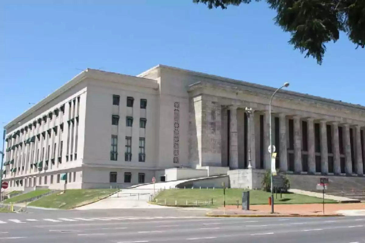 Classical architecture building with columns and wide staircases in an urban setting. Classical architecture building with columns and wide staircases in an urban setting.