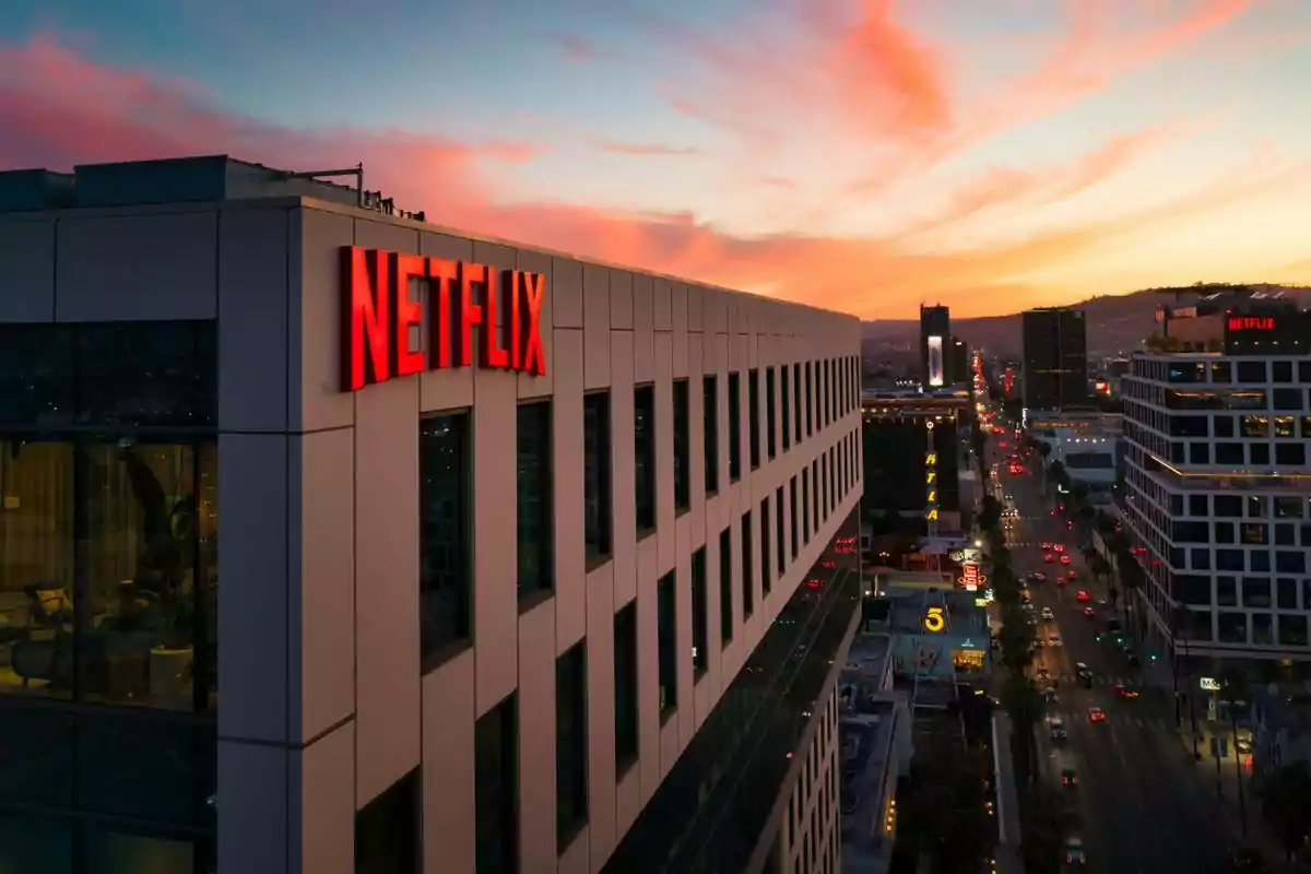 Edificio de oficinas de Netflix al atardecer con vista a una ciudad iluminada. Edificio de oficinas de Netflix al atardecer con vista a una ciudad iluminada.