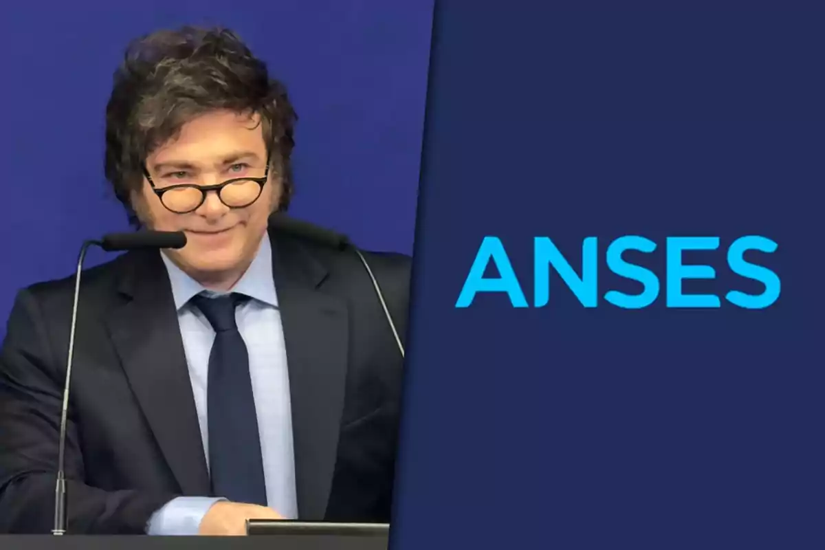 Dark-haired man with glasses speaking at a podium next to the ANSES logo against a blue background