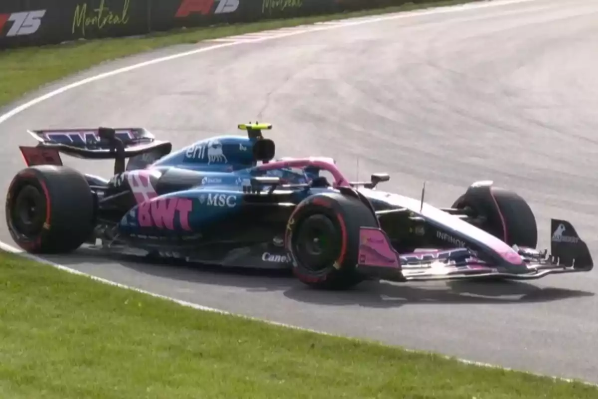 An Alpine Formula 1 car with blue and pink colors driving through a corner on a racetrack An Alpine Formula 1 car with blue and pink colors driving through a corner on a racetrack