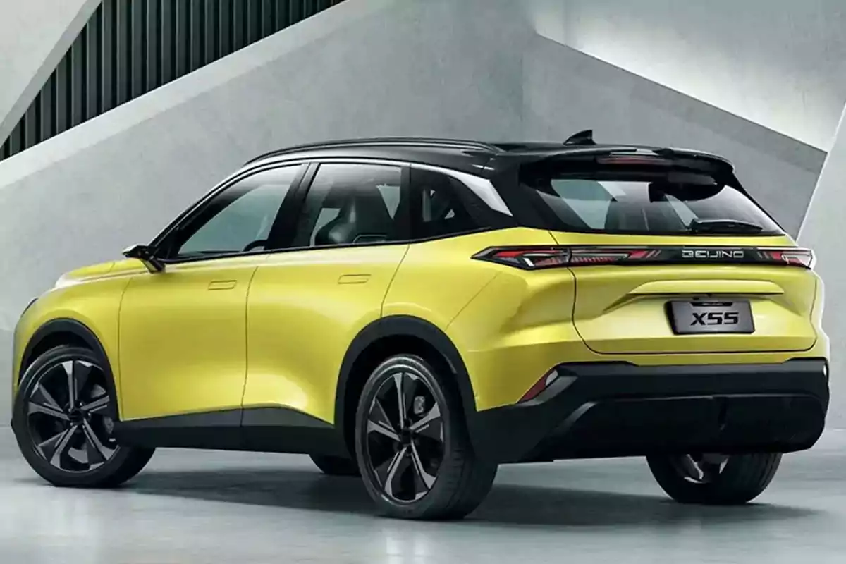Yellow SUV with a black roof parked in a modern setting with gray walls Yellow SUV with a black roof parked in a modern setting with gray walls