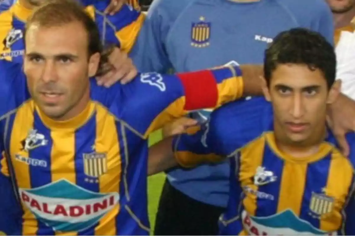 Two players in blue and yellow uniforms pose for a photo before a match. Two players in blue and yellow uniforms pose for a photo before a match.