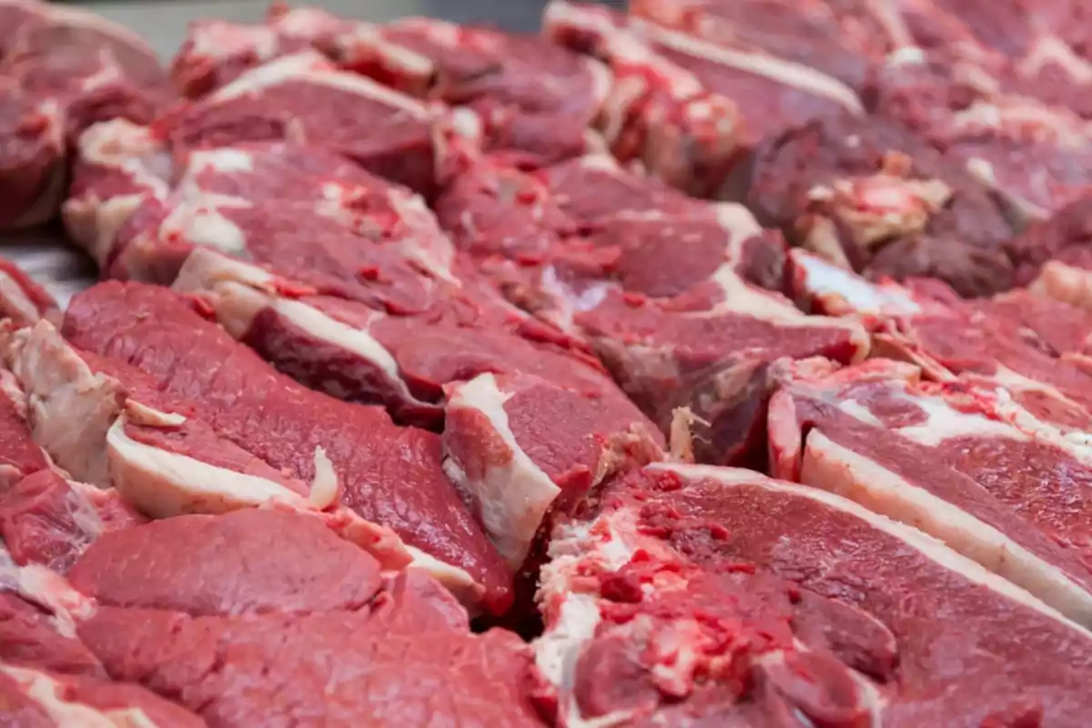 Various cuts of raw meat on display.