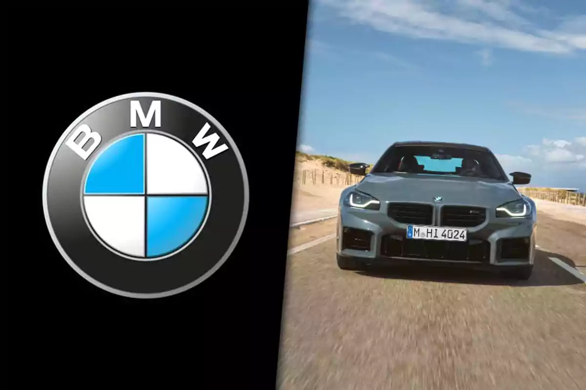 BMW logo next to a gray BMW car seen from the front on a road under a blue sky.