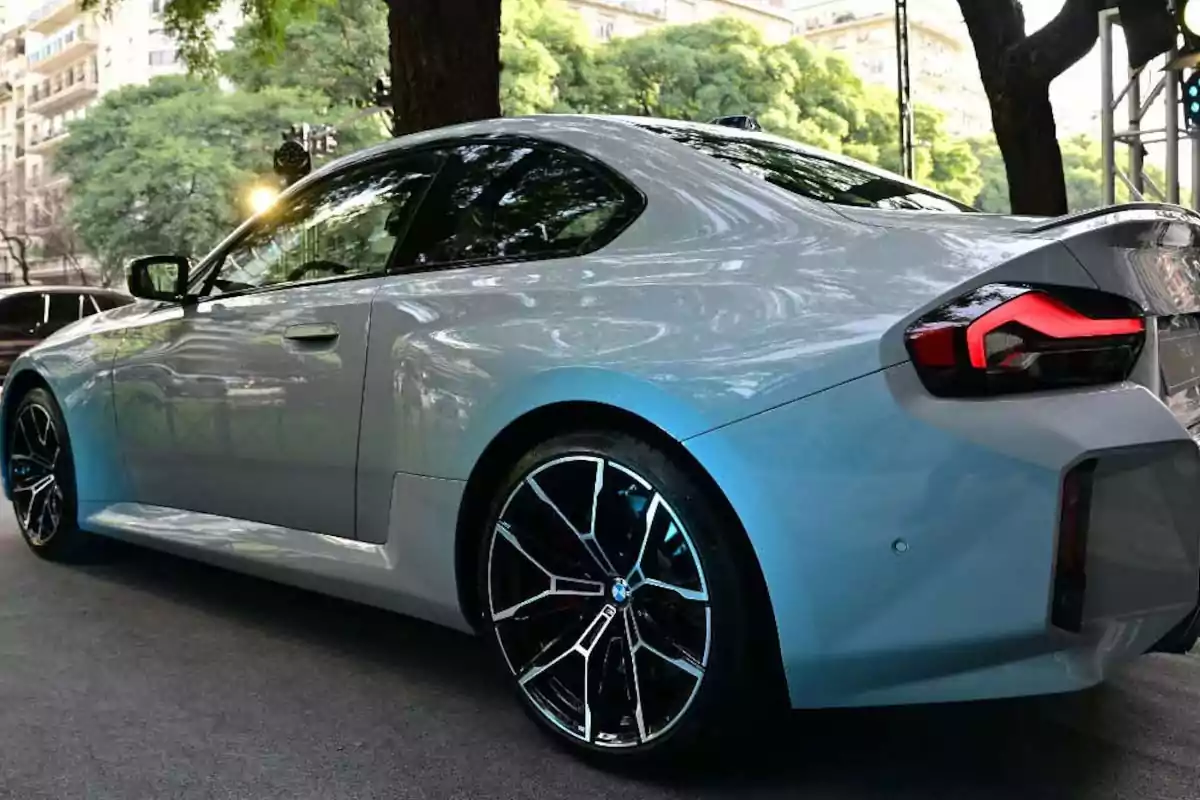 Gray BMW sports car parked on a tree-lined street Gray BMW sports car parked on a tree-lined street