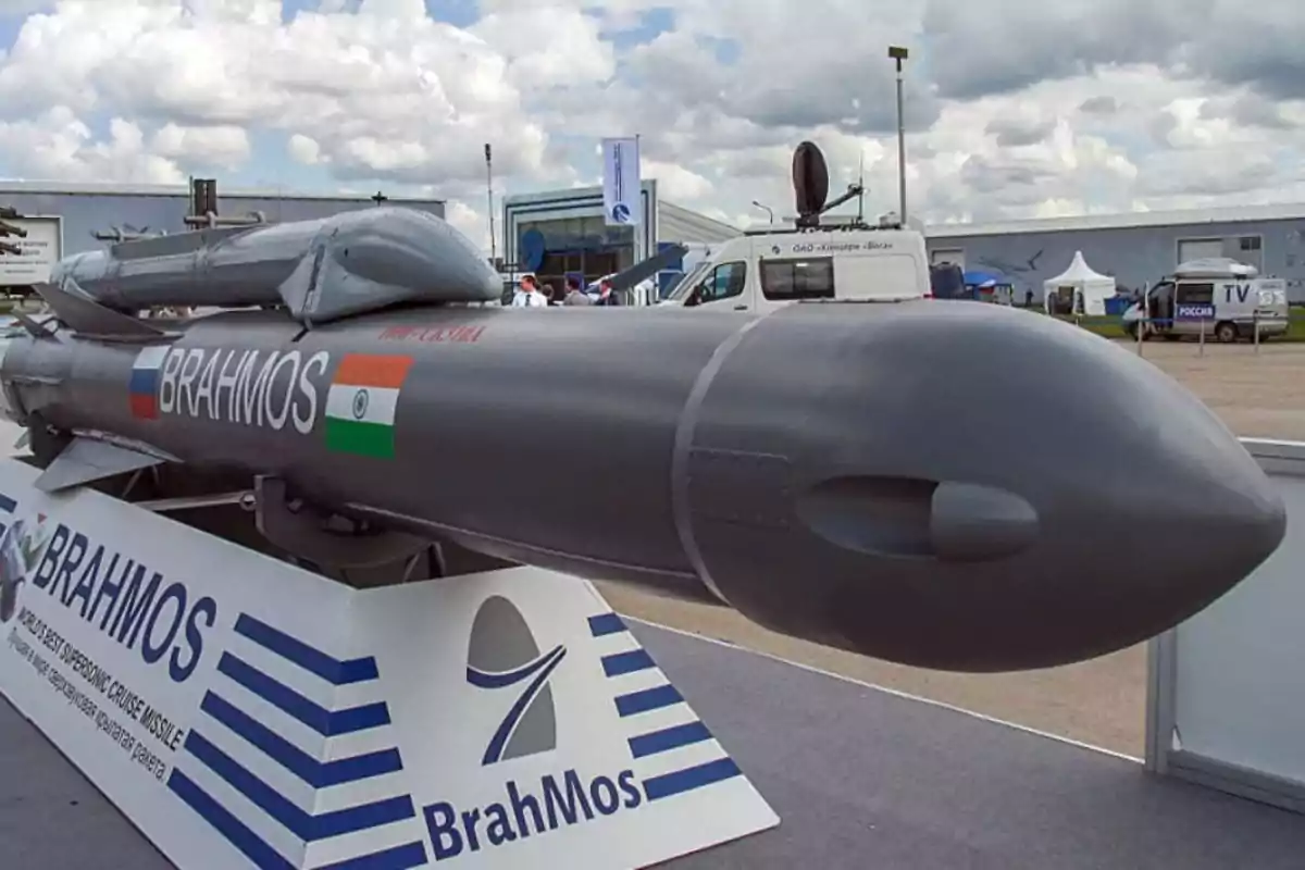 A supersonic BrahMos cruise missile displayed at an outdoor fair with a cloudy sky in the background. A supersonic BrahMos cruise missile displayed at an outdoor fair with a cloudy sky in the background.