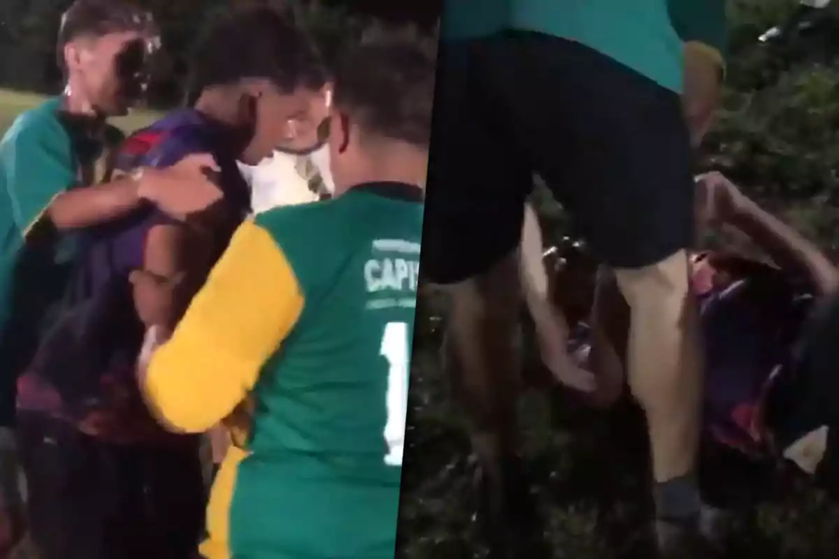 Un grupo de personas en un campo de fútbol parece estar ayudando a alguien que está en el suelo.
