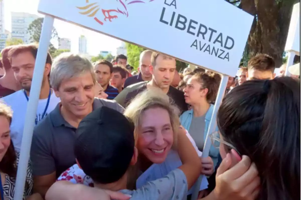 Un grupo de personas se reúne al aire libre sosteniendo un cartel que dice "La Libertad Avanza".