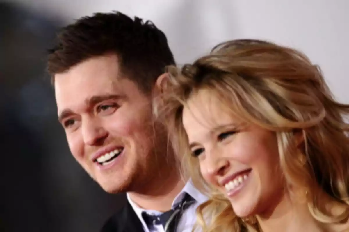 Two smiling people posing together at an event.