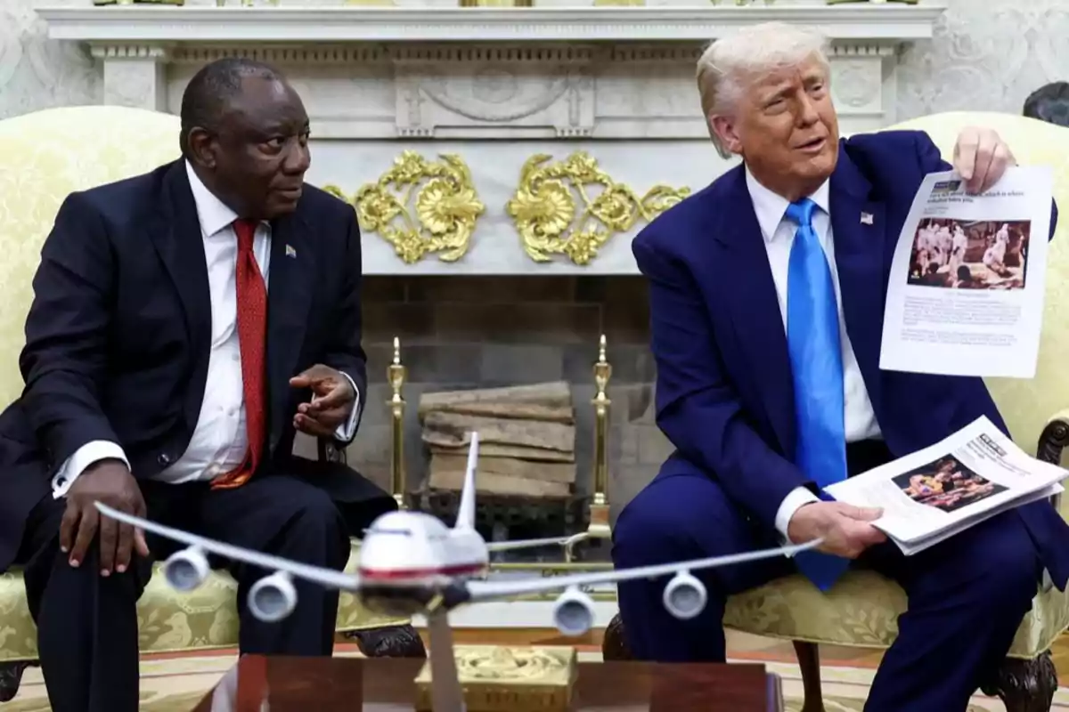 Two men sitting in an elegant room, one of them holding a document as they converse, with a model airplane on the table in front of them. Two men sitting in an elegant room, one of them holding a document as they converse, with a model airplane on the table in front of them.