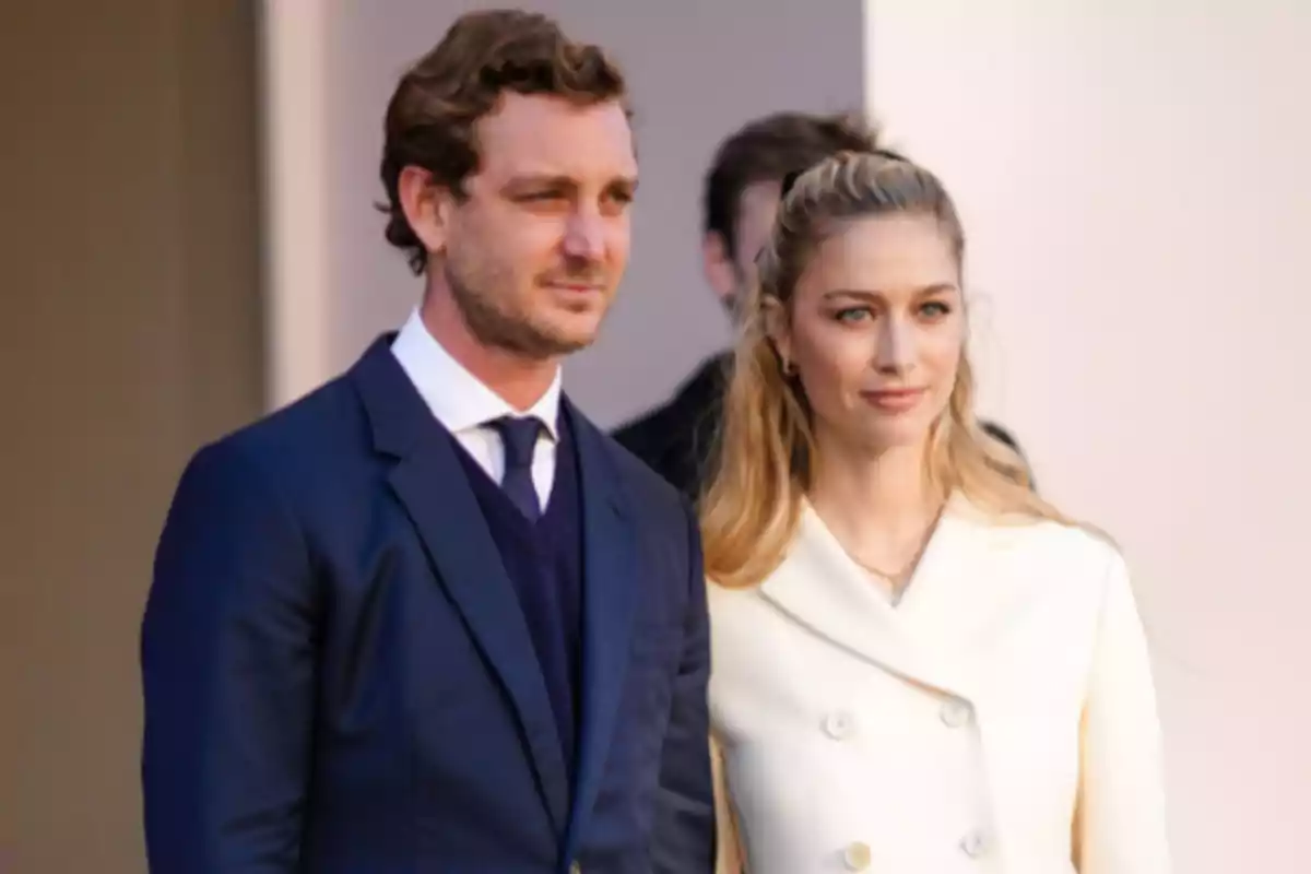 Elegantly dressed couple posing together at a formal event Elegantly dressed couple posing together at a formal event