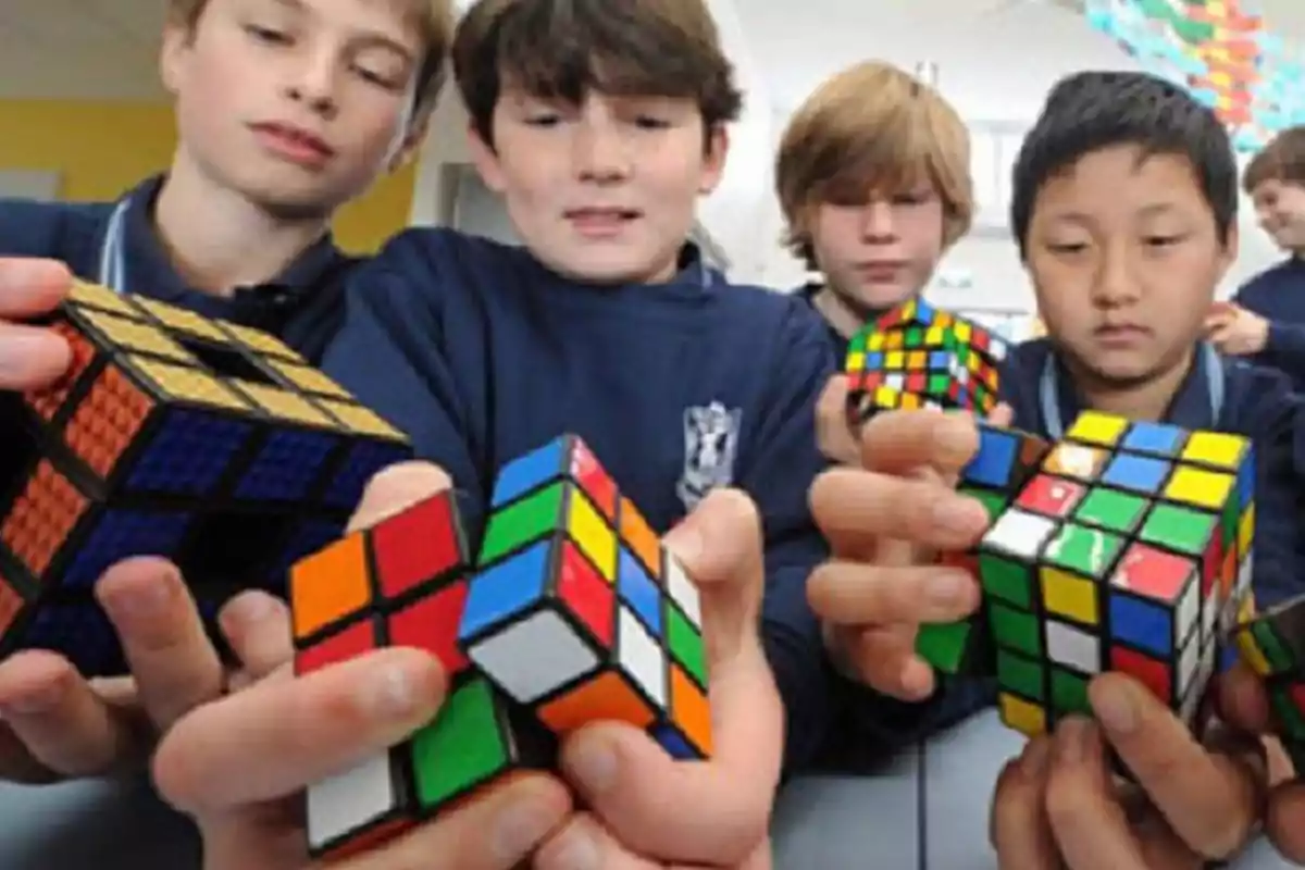 Several children solving Rubik's cubes while focusing on the challenge