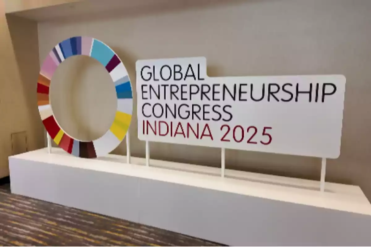 Poster of the Global Entrepreneurship Congress Indiana 2025 next to a decorative colored circle on a white background