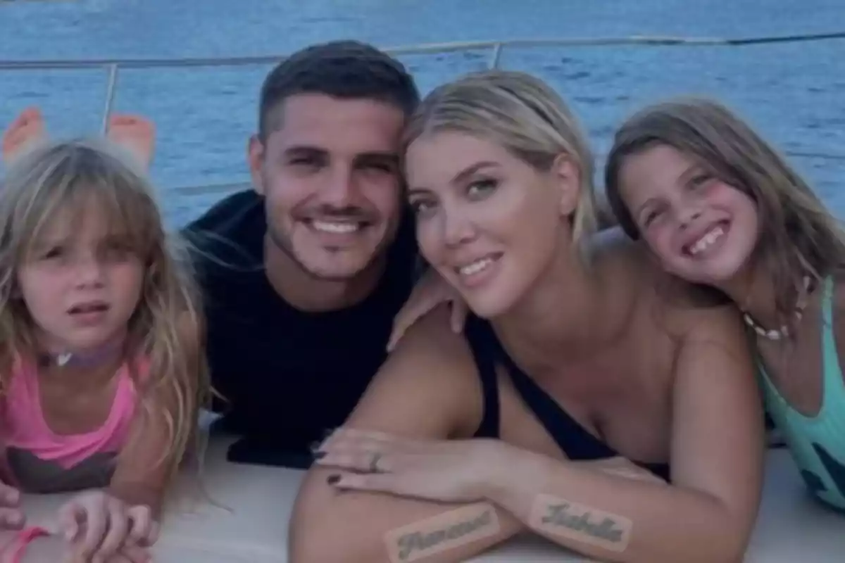 Family smiling and posing together on a boat with the sea in the background Family smiling and posing together on a boat with the sea in the background