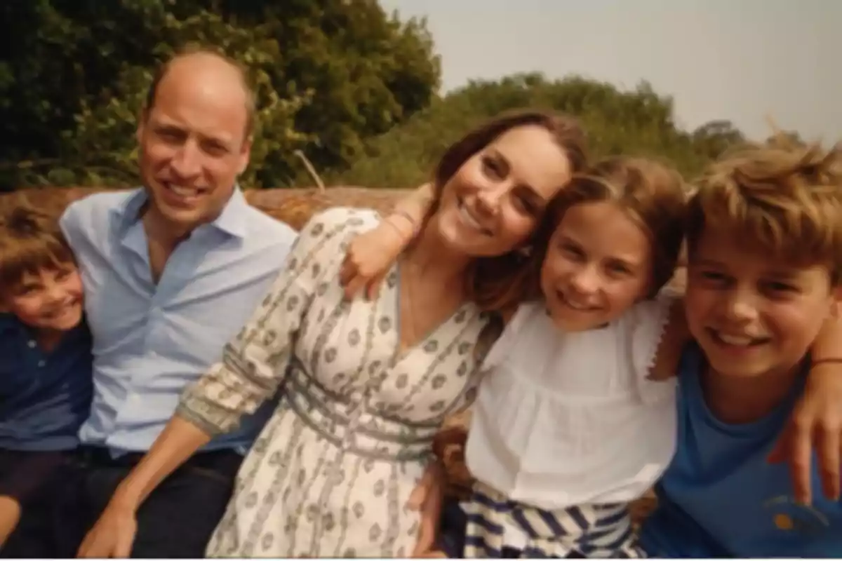 Smiling family hugging outdoors on a sunny day Smiling family hugging outdoors on a sunny day