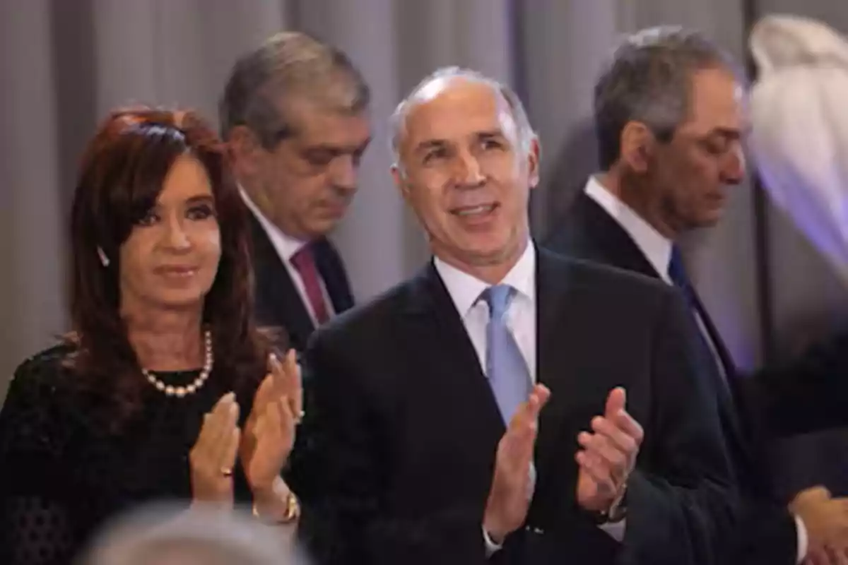 Personas elegantemente vestidas aplaudiendo en un evento formal