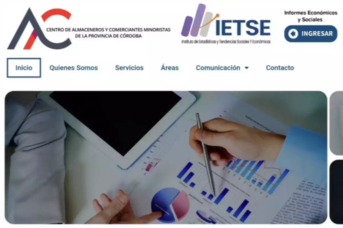 Website of the Center of Grocers and Retail Merchants of Córdoba with a navigation menu and an image of hands reviewing charts and a tablet