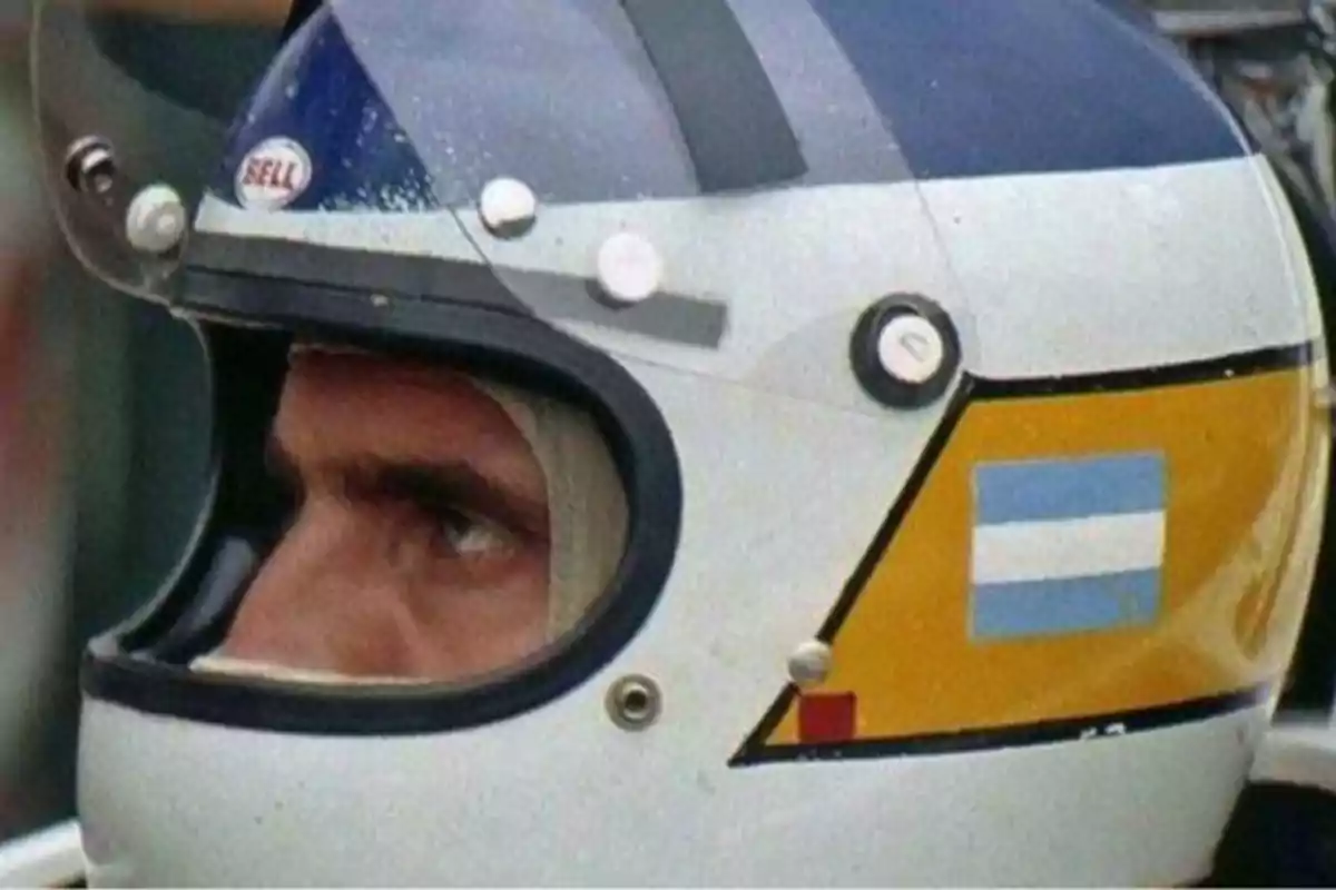 Primer plano de un piloto de carreras con casco que tiene la bandera de Argentina.