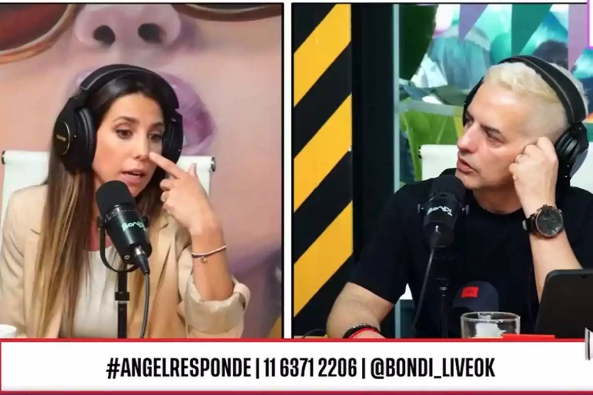 Two people with headphones and microphones are talking in a recording studio, one of them gesturing while the other listens alertly. Two people with headphones and microphones are talking in a recording studio, one of them gesturing while the other listens alertly.