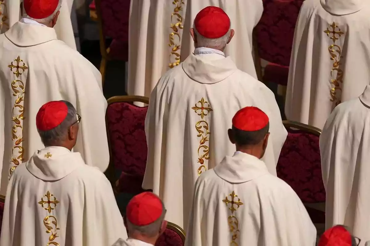 Group of clerics in white vestments and red zucchettos at a religious ceremony. Group of clerics in white vestments and red zucchettos at a religious ceremony.
