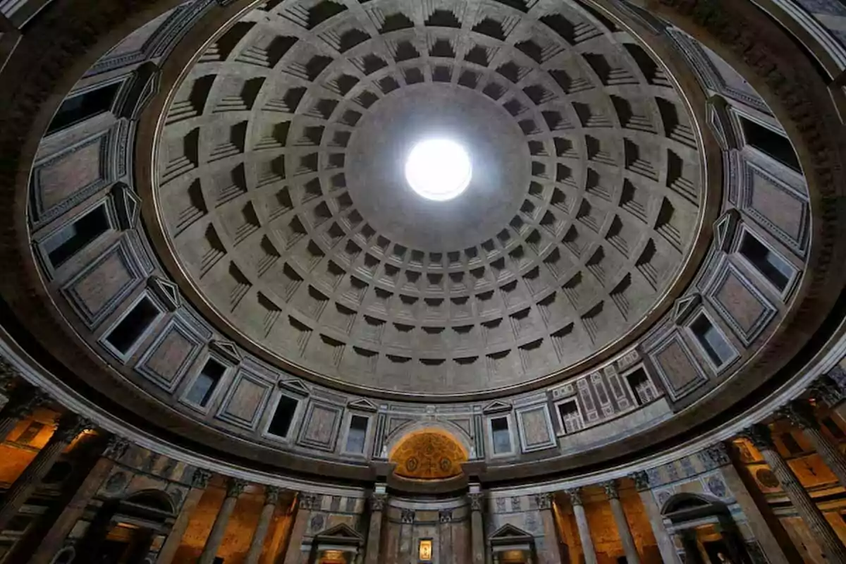 Interior of the Pantheon in Rome with its dome and illuminated central oculus. Interior of the Pantheon in Rome with its dome and illuminated central oculus.