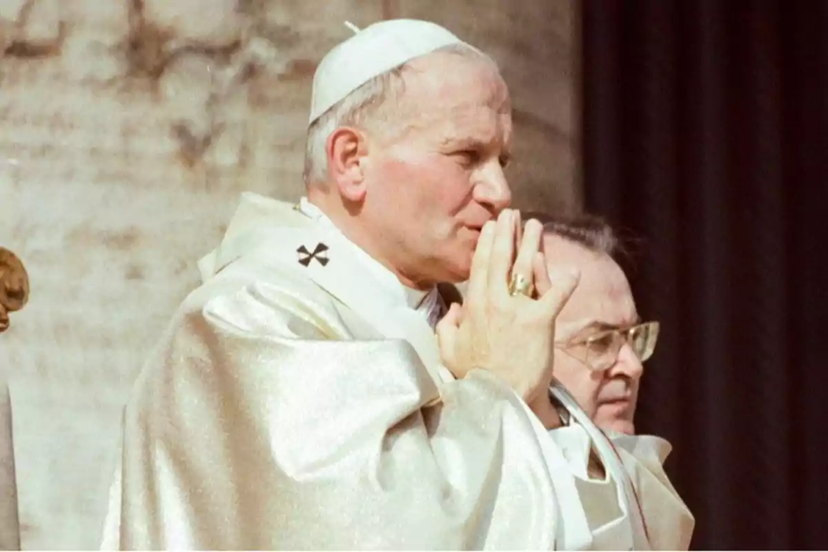 A religious leader dressed in white ceremonial attire, with hands joined in a prayerful attitude. A religious leader dressed in white ceremonial attire, with hands joined in a prayerful attitude.