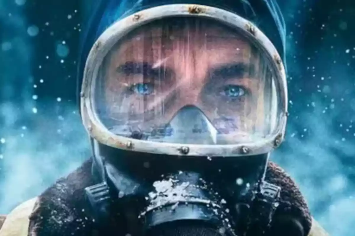 A man with a diving mask in an icy environment.