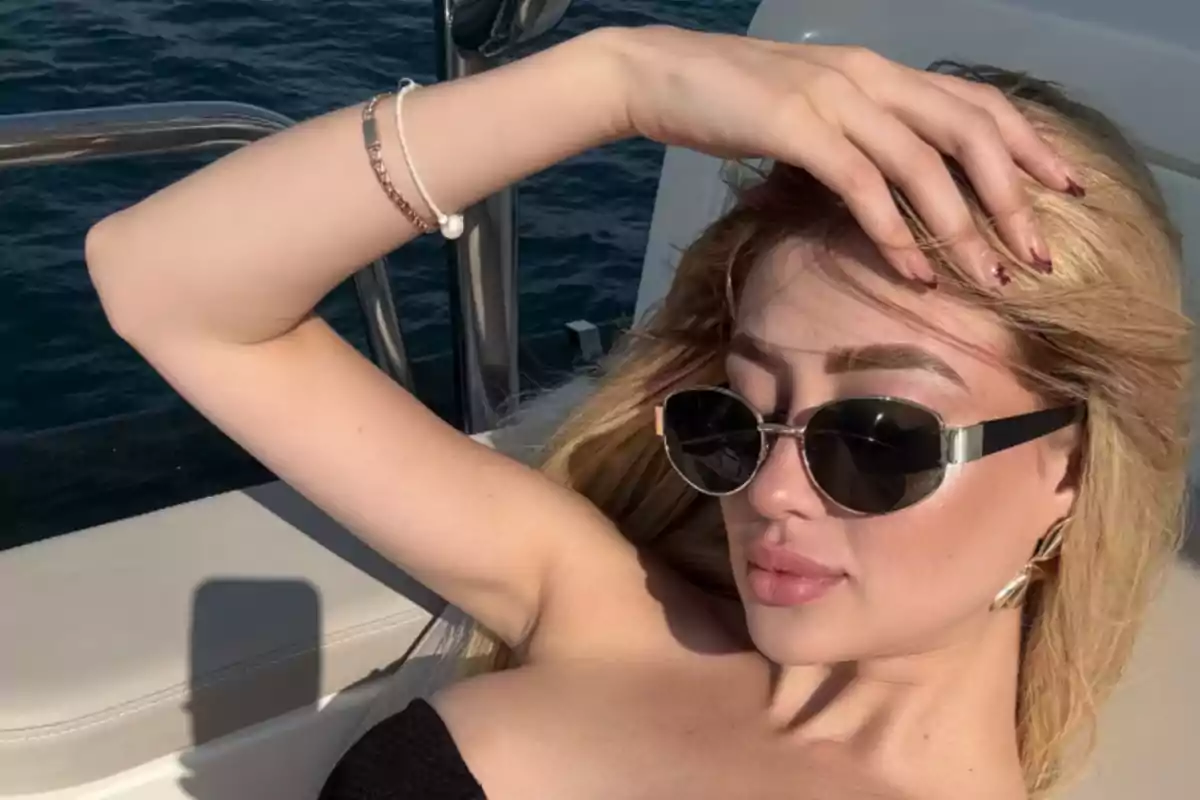 Person with sunglasses lying on a yacht under the sun. Person with sunglasses lying on a yacht under the sun.