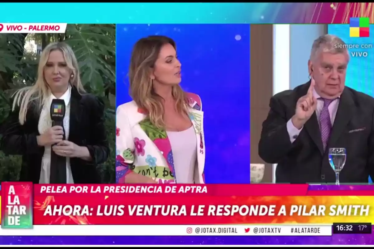 Three people are participating in a live television program: a reporter is outdoors with a microphone, a host is in the studio wearing a colorful blazer, and an older man in a suit is speaking while gesturing with his finger raised, as a news ticker on the screen mentions a discussion about the APTRA presidency.