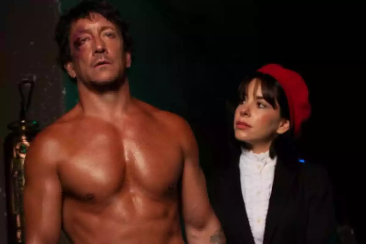 jerseyless man with a black eye next to a woman wearing a red beret and a white jersey