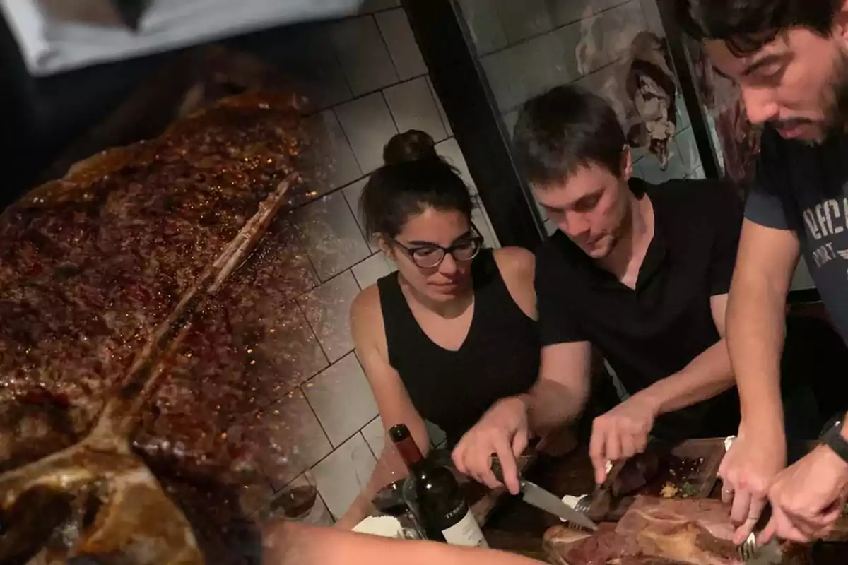 Personas cortando un gran trozo de carne en una mesa con una botella de vino en la Ciudad de Buenos Aires durante Año Nuevo 2025.