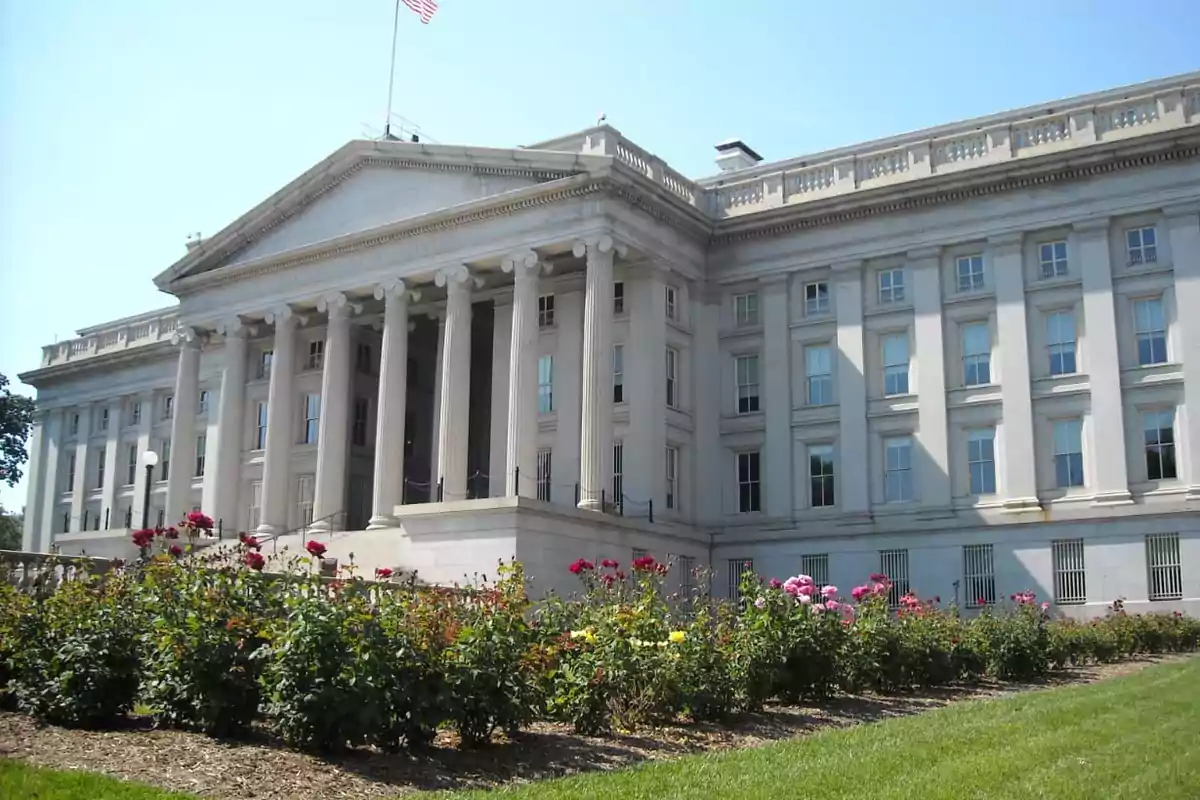 Neoclassical building with columns and a rose garden in front. Neoclassical building with columns and a rose garden in front.