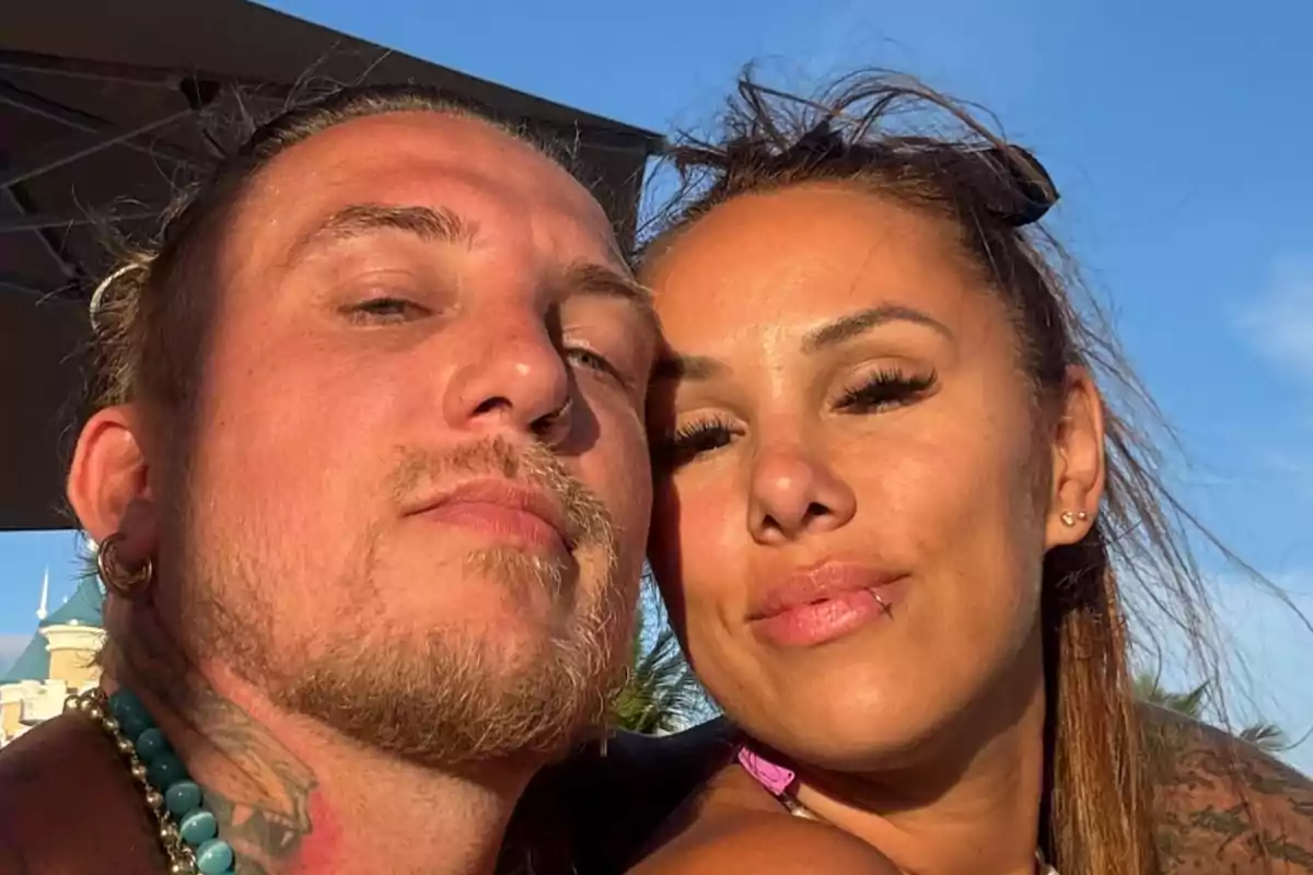 Young couple posing together outdoors under the sunlight