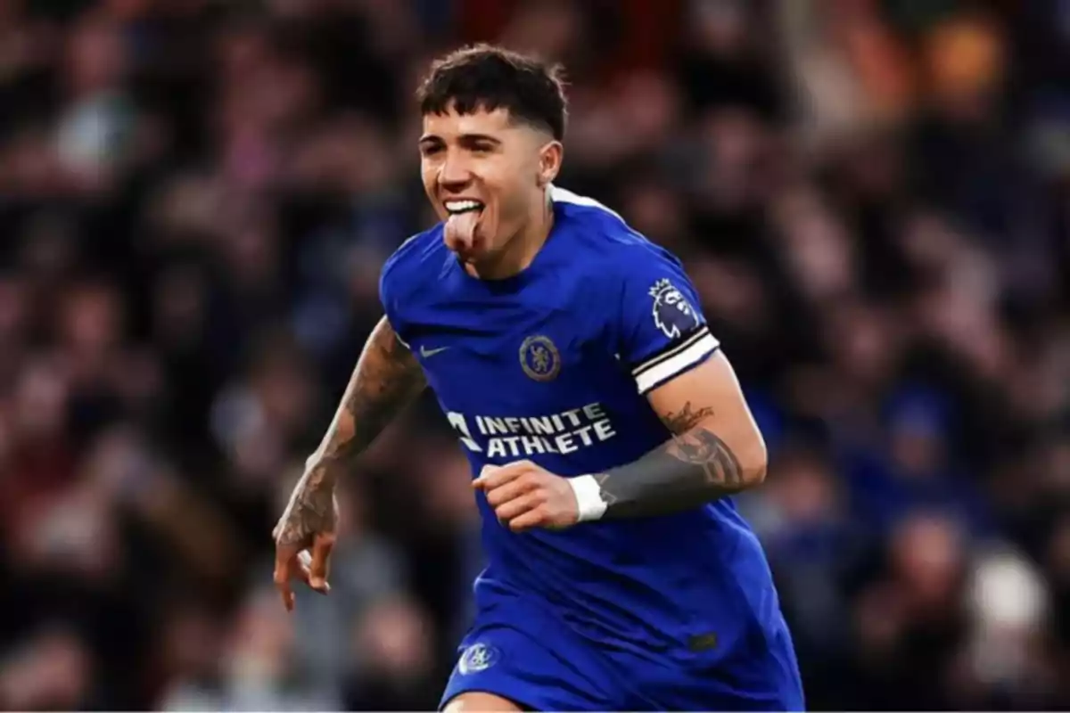A player in a blue uniform celebrates on the field with his tongue out.